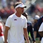 ole miss coach lane kiffin with players