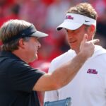 Head coach Lane Kiffin of the Mississippi Rebels speaks with head coach Kirby Smart of the Georgia Bulldogs