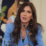 Homeland Security Secretary Kristi Noem speaks during a roundtable meeting with President Donald Trump on antifa in the State Dining Room at the White House, Wednesday, October 8, 2025, in Washington.