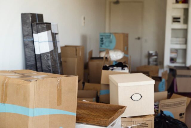 House moving, packed unpacked carton boxes, messy home