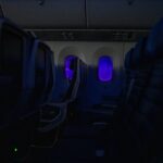 Empty passenger airplane seats in the cabin at night