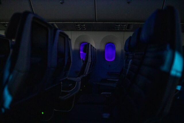 Empty passenger airplane seats in the cabin at night