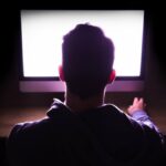 Um homem olha para a tela de um computador.