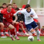 Shea Lacey driblando pela Inglaterra Sub-20.