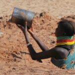 Duas mulheres turkana carregando água através da paisagem árida