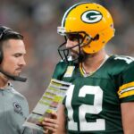 Head coach Matt LaFleur of the Green Bay Packers talks to Aaron Rodger
