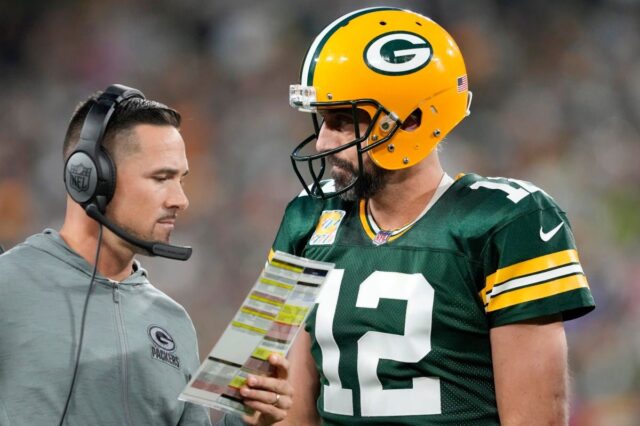 Head coach Matt LaFleur of the Green Bay Packers talks to Aaron Rodger