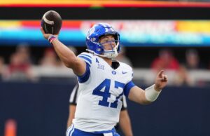 Previsão de Utah x BYU: probabilidades, escolhas, melhor aposta para a ‘Guerra Santa’ de sábado Três jogadores do Utah Utes vestindo camisetas e capacetes vermelhos se parabenizam após um touchdown.