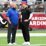 Head coach Brian Daboll of the New York Giants speaks with head coach Jonathan Gannon of the Arizona Cardinals