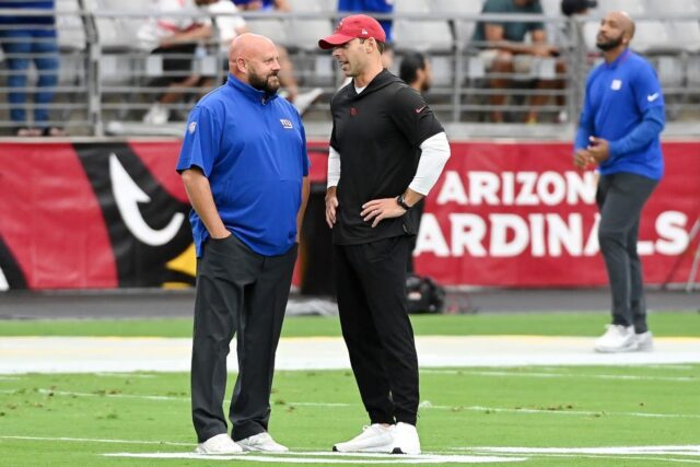 Head coach Brian Daboll of the New York Giants speaks with head coach Jonathan Gannon of the Arizona Cardinals