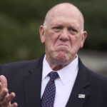 President Donald Trump listens as White House border czar Tom Homan speaks at an event to promote his domestic policy and budget agenda in the East Room of the White House, Thursday, June 26, 2025, in Washington. (AP Photo/Jose Luis Magana)