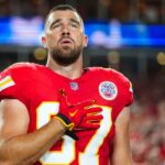 Baltimore Ravens defenders attempting to tackle Chiefs star Travis Kelce