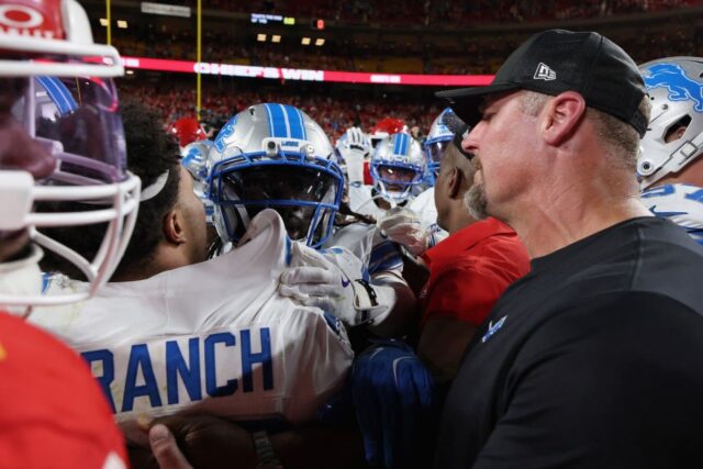 Head coach Dan Campbell of the Detroit Lions speaks to Brian Branch #32 after the game against the Kansas City Chiefs at Arrowhead Stadium