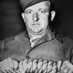 O carrasco americano, sargento John C Woods, um vagabundo com orelhas de abano, jogador e bebedor inveterado