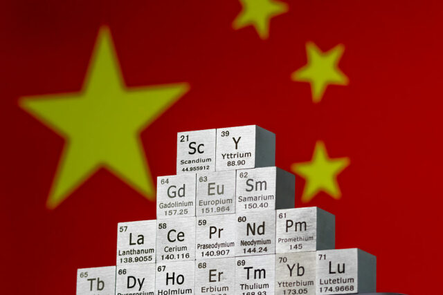 China está revertendo restrições a minerais de terras raras, diz In this photo illustration, metal cubes representing rare earth elements including Scandium (Sc), Yttrium (Y), Neodymium (Nd), Lanthanum (La), and others are stacked in a stepped formation in front of the national flag of China