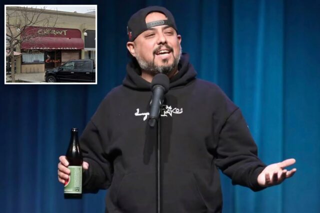 Anthony Krayenhagen, comediante, se apresentando no palco com um microfone e uma garrafa de cerveja.