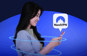Depois de usar NordVPN por um mês, cansei de usar VPNs gratuitas Uma mão segurando um controle remoto de TV aponta para uma smart TV exibindo aplicativos de streaming, sobrepostos por um grande ícone de escudo e a palavra ‘VPN’.