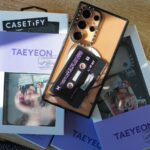 Um controlador de cachorro-quente Oscar Mayer, um telefone Huawei KFC e um telefone Realme Coca-Cola com 'estranho' escrito no centro.