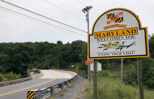 Maryland se torna o último estado a alertar os licenciados sobre mercados de previsão Lado de uma estrada que faz uma curva para a esquerda, com uma placa no lado direito que diz 'Maryland lhe dá as boas-vindas, aproveite sua visita!' Maryland se torna o último estado a alertar os licenciados sobre mercados de previsão