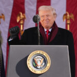 ARQUIVO - Nesta foto de arquivo de 6 de junho de 2019, o presidente Donald Trump está com veteranos da Segunda Guerra Mundial durante uma cerimônia para marcar o 75º aniversário do Dia D no Cemitério Americano da Normandia em Colleville-sur-Mer, Normandia, França. A maioria dos veteranos militares aprova o desempenho do Presidente Donald Trump como comandante-chefe, reflectindo o apoio contínuo de um grupo que o apoiou fortemente durante a sua presidência. Ainda assim, muitos veteranos acreditam que ele não ouve suficientemente os líderes militares e desconfia das suas decisões sobre o uso da força. (Foto AP/David Vincent)