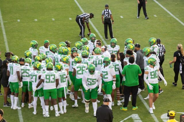 The Oregon Ducks huddle on the field during a Pac-12 NCAA college football game against the Stanford Cardinal