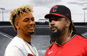 Os jogadores da MLB Emmanuel Clase e Luis Ortiz acusados de apostas esportivas e conspiração para lavagem de dinheiro Os jogadores da MLB Emmanuel Clase e Luis Ortiz acusados de apostas esportivas e conspiração para lavagem de dinheiro. Dois jogadores de beisebol em frente a um campo de beisebol. O jogador da esquerda tem cabelos loiros curtos e cacheados e sorri enquanto veste uma camisa branca e uma corrente dourada. O jogador da direita tem longas tranças escuras, barba e veste uma camisa de beisebol vermelha e um boné preto com um 'C' vermelho. O fundo mostra um campo de beisebol em tons de cinza e luzes do estádio.