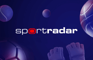 Sportradar adquire IMG ARENA para impulsionar esforços globais de expansão de dados esportivos Logotipo da Sportradar exibido em um fundo azul escuro com elementos esportivos estilizados, incluindo bola de tênis, bola de golfe, basquete, bola de futebol e luvas de goleiro. Sportradar adquire IMG ARENA para impulsionar esforços globais de expansão de dados esportivos