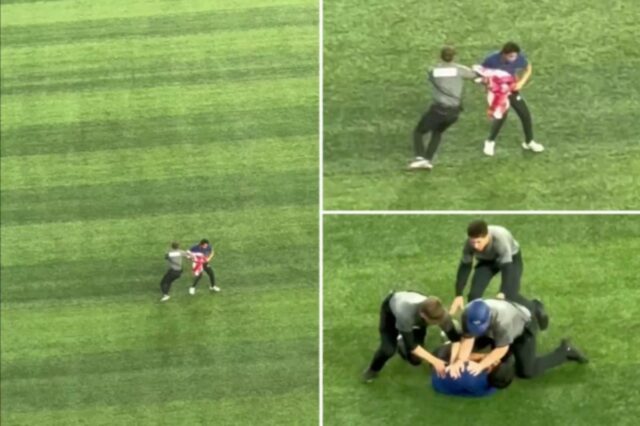 Torcedor corre para campo com bandeira americana para atrasar o Segurança perseguindo um torcedor com bandeira canadense em campo.