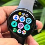 Pessoa que usa um Galaxy Watch com ícones flutuantes mostrando recursos como frequência cardíaca, pagamentos sem contato, alertas e RA.
