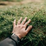 hand touching grass