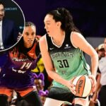 Breanna Stewart, do New York Liberty, segurando uma bola de basquete enquanto é guardada por um jogador do Phoenix Mercury.