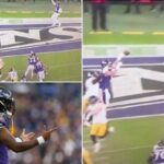 Jogadores do Baltimore Ravens em campo durante um jogo de futebol.