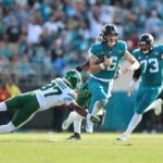 Trevor Lawrence # 16 do Jacksonville Jaguars luta durante o segundo quarto contra o New York Jets.