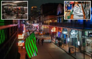 DHS anuncia Nova Orleans como última cidade varrida pela repressão à imigração Bourbon Street à noite com pedestres, letreiros de néon e uma bandeira americana iluminada em verde.