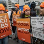 Médicos residentes ontem fizeram piquetes no primeiro de sua greve de cinco dias por causa de salários e condições de trabalho. Na foto, médicos do lado de fora do hospital Guys & St Thomas em Westminster ontem