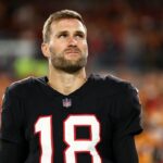 Kirk Cousins #18 of the Atlanta Falcons stands on the sidelines during the national anthem prior to the NFL football game against the Tampa Bay Buccaneers at Raymond James Stadium on December 11, 2025 in Tampa, Florida.