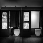 A black and white picture of two photo booths.