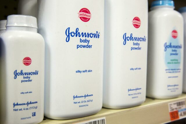 Frascos de talco para bebês Johnson & Johnson em uma prateleira de drogaria.