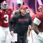 Alabama head coach Kalen DeBoer with Crimson Tide players