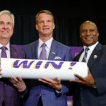 Lane Kiffin, (C) poses for a photo with LSU president Dr. Wade Rousse, (L) and LSU interim athletic director Verge Ausberry