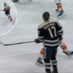 Mat Barzal dá corda para acertar Mason Marchment durante um jogo no domingo.