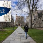 Um estudante caminha pela Library Walk no campus da Universidade de Yale.