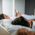 Pessoas carregando um caixão com flores brancas para uma igreja.