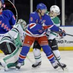 JT Miller luta por posição com Ilya Lyubushkin durante a vitória do Rangers no OT sobre os Stars em 2 de dezembro de 2025.