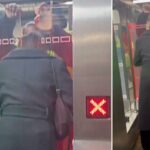 Uma pessoa com um casaco preto tenta entrar na catraca do metrô mostrando um símbolo 'X' vermelho.