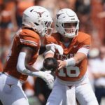 Arch Manning #16 of the Texas Longhorns hands off to CJ Baxter