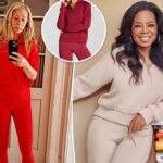 Mulher vestindo um moletom vermelho com zíper e leggings combinando.