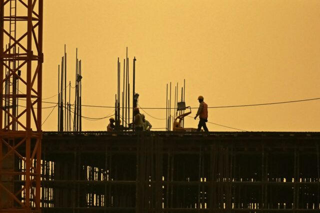 Men work at under construction site in New Delhi