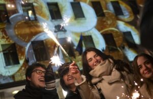 Bulgária adota euro em meio a comemorações e ansiedade em relação à inflação Os passageiros passam por um anúncio promovendo a entrada da Bulgária na zona do euro no metrô de Sófia em 31 de dezembro de 2025, antes da adoção do euro pelo país em 1º de janeiro de 2026. (Foto de Nikolay DOYCHINOV / AFP)