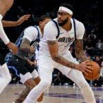 O atacante do Dallas Mavericks, Anthony Davis, à direita, enfrenta o guarda do Utah Jazz, Keyonte George, no centro, durante o primeiro tempo de um jogo de basquete da NBA, quinta-feira, 8 de janeiro de 2026, em Salt Lake City.